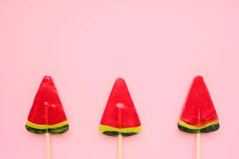 Watermelon popsicle on pink colored backdrop. Stock Photos