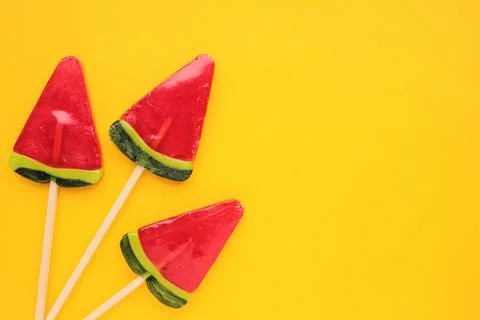 Watermelon popsicle on yellow colored backdrop. Stock Photos