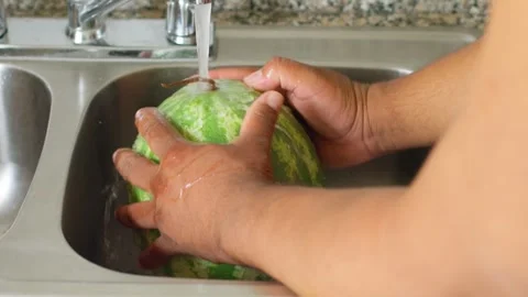 A watermelon is sitting in a sink Stock Footage 310187111