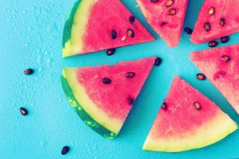 Watermelon slice popsicles on a blue background Stock Photos