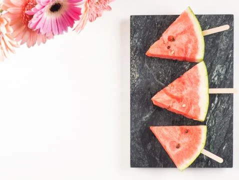 Watermelon slice popsicles on marble tray Stock Photos