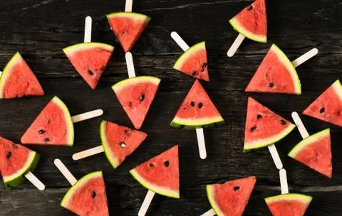 The watermelon slice popsicles on a rustic wood background Stock Photos