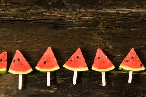 The watermelon slice popsicles on a rustic wood background. copy space for .. Stock Photos