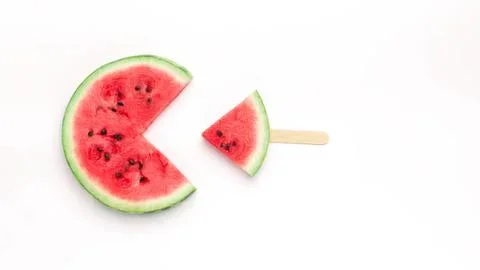 Watermelon slice with a small popsicle stick on white background Stock Photos