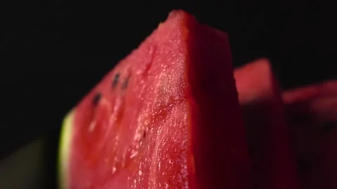 Watermelon sliced triangles with shallow depth of field, seeds visible, black Stock Footage 317540217