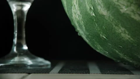 Watermelon on the table, water dripping from it Stock Footage 133725384