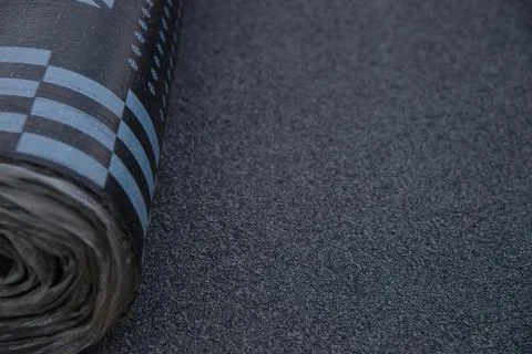 Waterproof bitumen roll covered with insulation materials. Stock Photos
