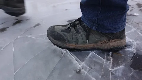 Waterproof shoe breaking thin ice cracking sound winter danger close up Stock-Footage 331555161