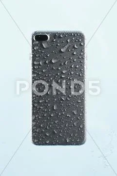 Waterproof smartphone covered with water Stock Photos