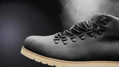 A waterproof spray is applied to the shoes Stock Footage 117639257