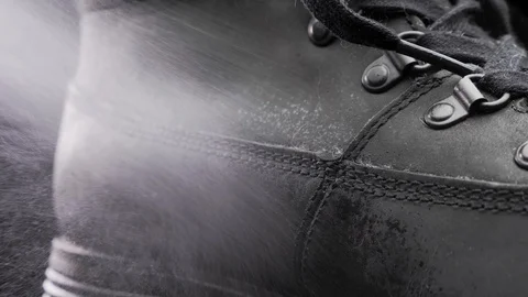 A waterproof spray is applied to the shoes Stock Footage 117639339