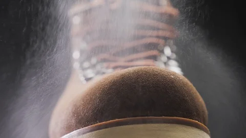 A waterproof spray is applied to the shoes Stock Footage 118937994