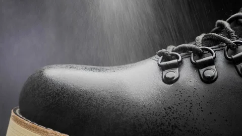 A waterproof spray is applied to the shoes Stock Footage 118938051