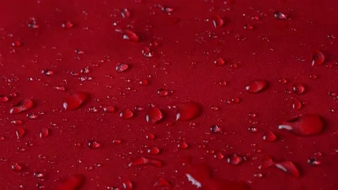 Waterproof textile cloth concept. Rain, water drops are splashing on coat but Stock-Footage 176360598