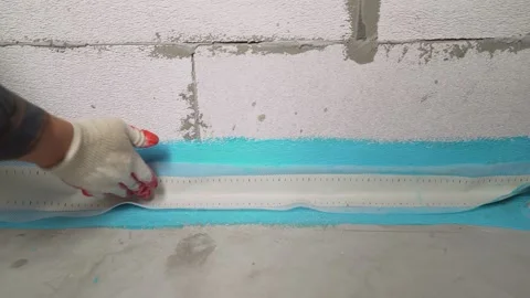 Waterproofing the bathroom floor. The proper placement of sealing tape Stock Footage 157473182
