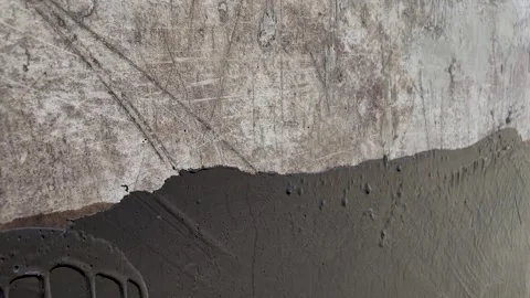 Waterproofing a concrete wall with liquid bitumen Stock Footage 252269448