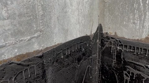 Waterproofing a concrete wall with liquid bitumen Stock Footage 298520619