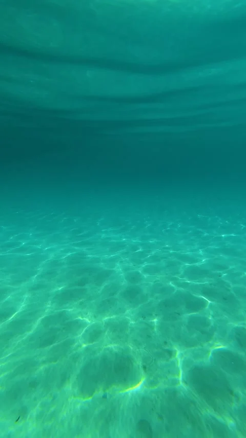 The water's deep turquoise hue flows. Trani Ammouda, Greece. Vertical Vídeos de archivo 338358003