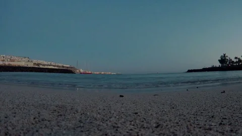 Water's edge waves in a bay during the nightfall Stockbeeldmateriaal 79734362