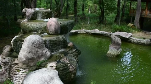 Waters flowing from miniature waterfall. Stock Footage 142009392