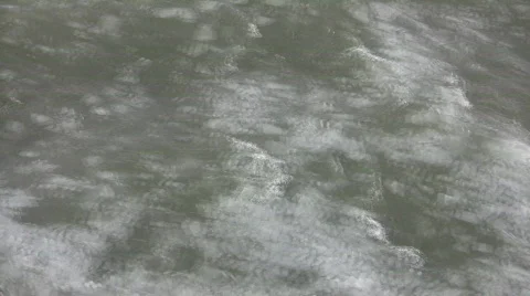 Water's icy surface is rough as it flows (High Definition) Stock Footage 64450
