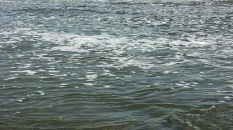 Water's surface bubbles and moves against a strong backlight Stock Footage 364926