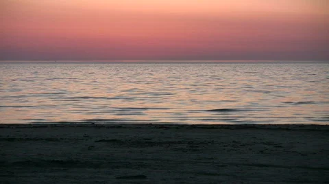 Water's surface reflects the orange sky at dawn (High Definition) Stock Footage 364978