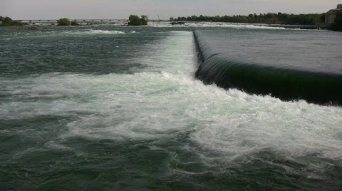 Water's is turbulent as it flows over weir (High Definition) Stock Footage 365170