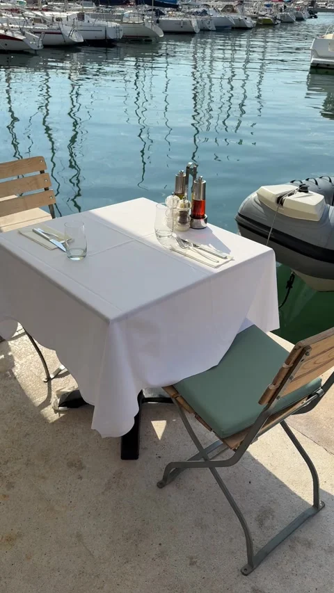 Waterside cafe table at the marina vertical video Stock Footage 319401207
