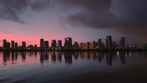 Waterside cityscape at dawn. Water surface reflection. Osaka Umeda Yodogawa Stock Footage 158705624