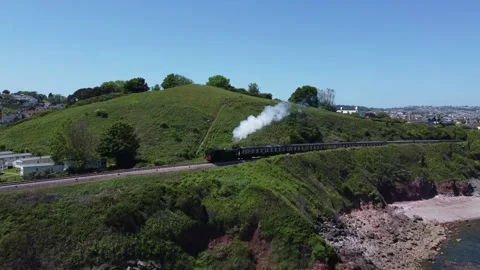 Waterside Park, Devon, England: Drone View: Steam train heading to Kingswear Stock Footage 195938347