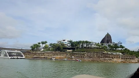 Waterside View of El Peñol with Rock Landmark Stock Footage 286381406
