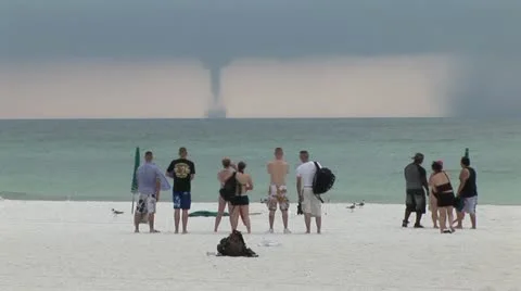 Waterspout with people on sandy beach Stock-Footage 12574559