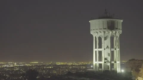 Watertower at Night with City in the Background Stock Footage 65964028