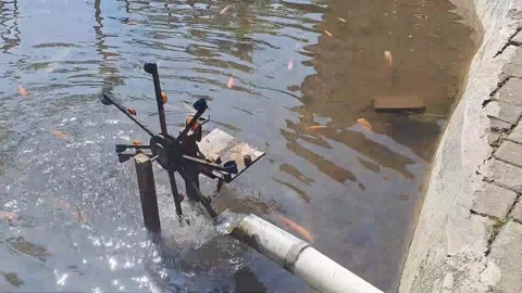Waterwheel system for circulating water and oxygen in artificial ponds Stock Footage 244100635