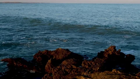 Wave advancing on a rocky beach Stock Footage 150771857