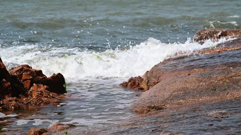 Wave and rock at slow motion Stock Footage 334609018
