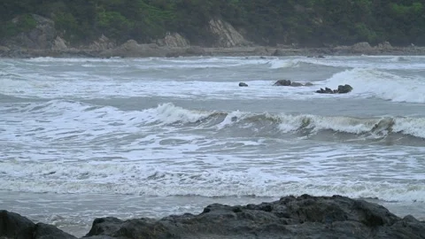 Wave and rocks in slow motion Stock Footage 308759444