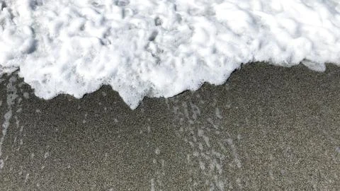 Wave and sand. Stock Photos