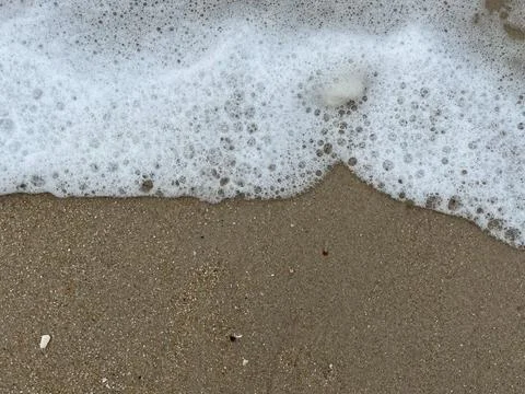 Wave and the sand Stock Photos