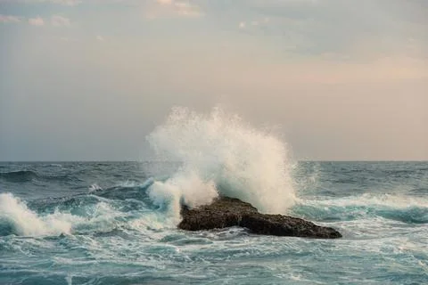 Wave and splashes on beach at sunset. Beautiful sunset at Sri Lanka. Stock Photos