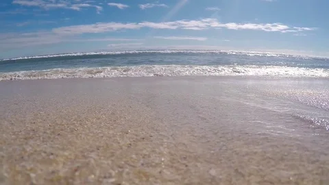 A wave approaching the camera buried in the sand Stock Footage 77385201