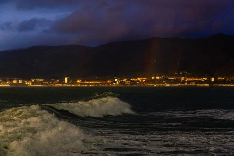 Wave on the background of the city at sunset	 Stock Photos