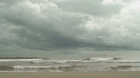 Wave on the beach, Clouds hovering low covering the sky with raining Stock Footage 221214820