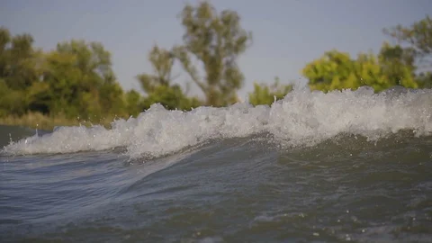 A wave from a boat on the river Stock Footage 97146367