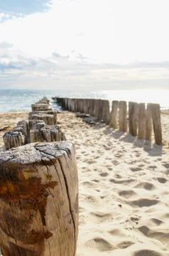 Wave breakers at the beach with clouds Stock Photos