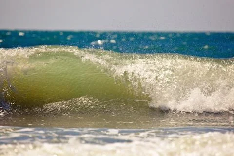 Wave breaking on the beach Stock Photos