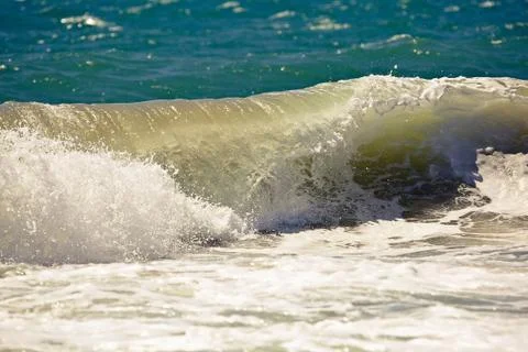 Wave breaking on the beach Stock Photos