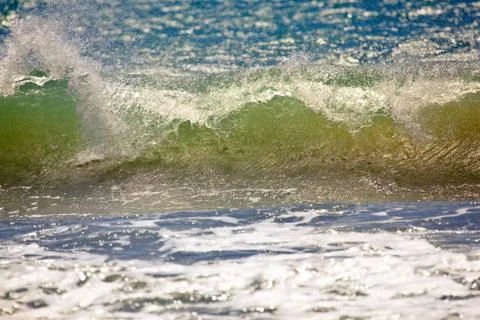 Wave breaking on the beach Stock Photos