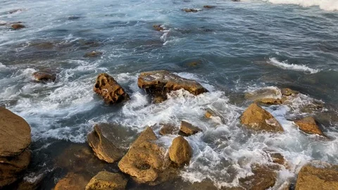 Wave breaking into coastal rock Stock Footage 89704762